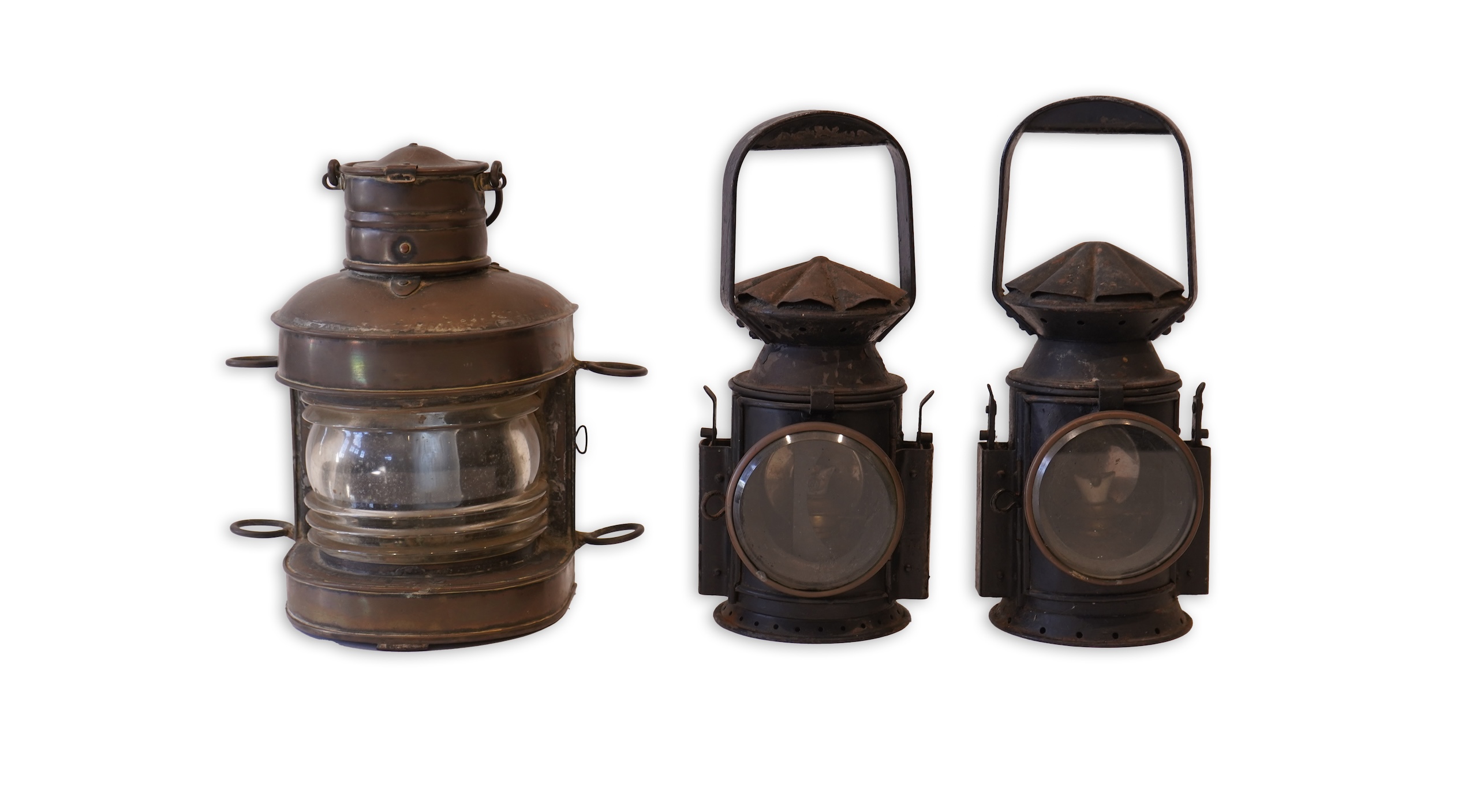 Two black painted railway hand lamps by Pratt & Co. Ltd. Birmingham, both dated 1945, both with burners and reflections, one intended for three colour aspect, with one glass missing, together with a brass ship’s bulkhead